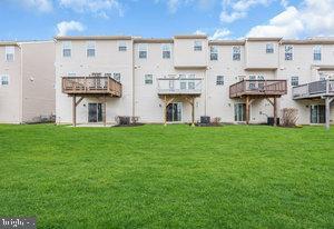 rear view of property featuring a lawn