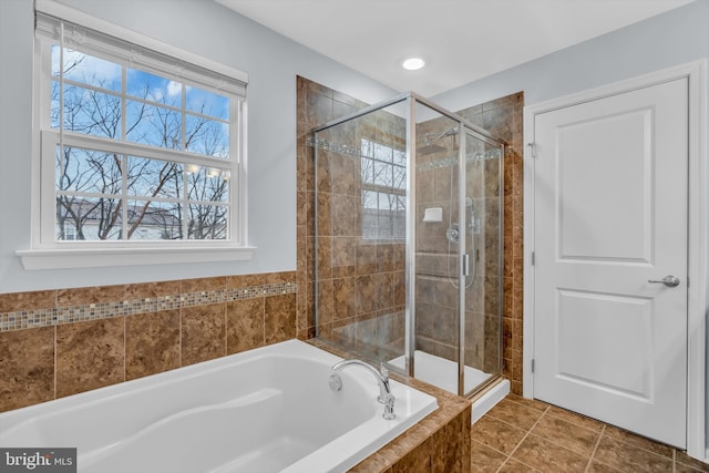 bathroom with tile patterned floors and shower with separate bathtub