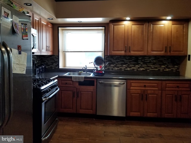 kitchen featuring decorative backsplash, sink, and stainless steel appliances