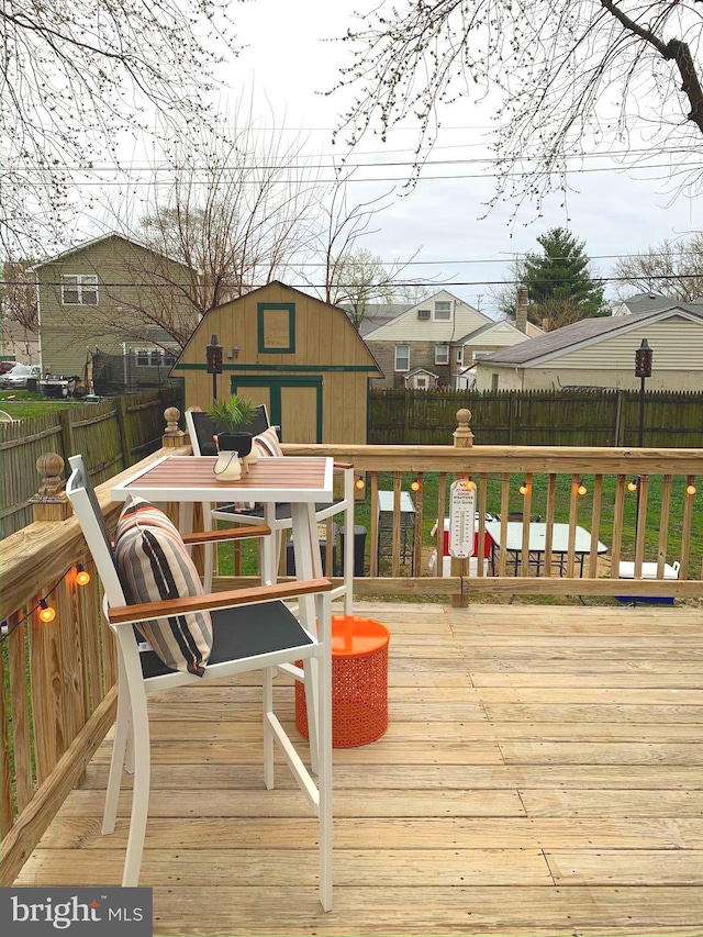 wooden terrace with a shed