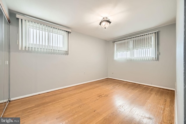 empty room with hardwood / wood-style flooring