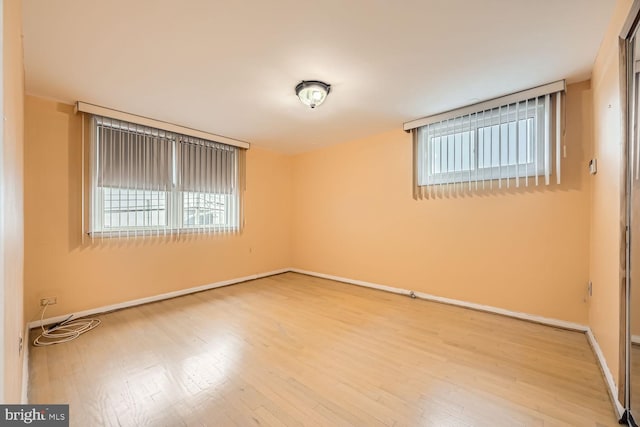 unfurnished room with wood-type flooring