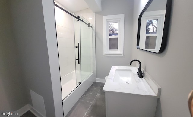 bathroom with vanity and bath / shower combo with glass door