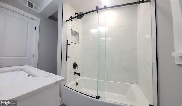 bathroom featuring vanity and shower / bath combination with glass door