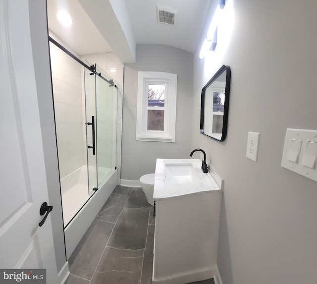 full bathroom with vanity, toilet, and shower / bath combination with glass door