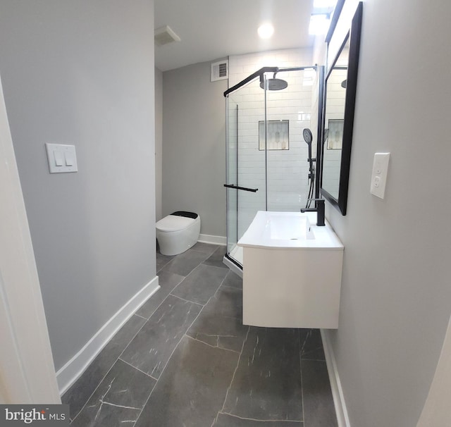 bathroom with vanity, toilet, and walk in shower