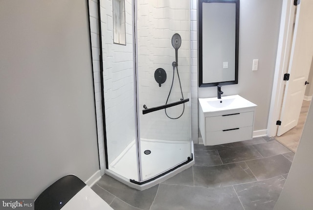 bathroom featuring vanity and a shower with door