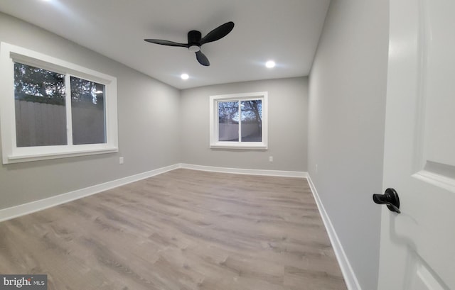 spare room featuring light hardwood / wood-style flooring and ceiling fan