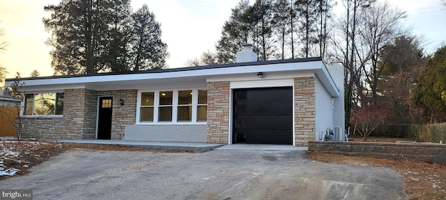 view of garage at dusk