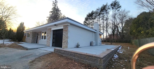 property exterior at dusk with a patio