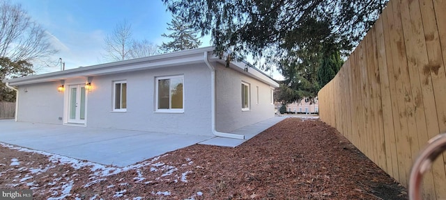 view of property exterior with a patio area