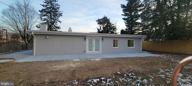 rear view of property with french doors and a patio