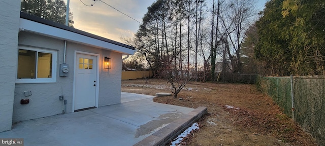 yard at dusk with a patio area