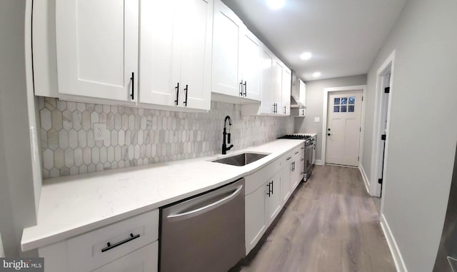 kitchen with white cabinetry, sink, stainless steel appliances, and light wood-type flooring