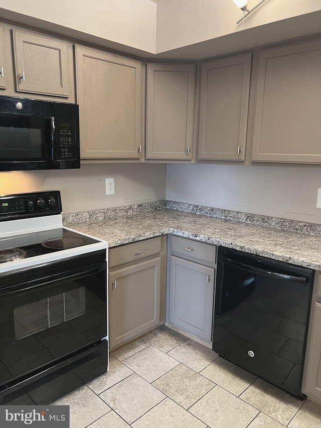 kitchen with light tile patterned floors, gray cabinets, and black appliances