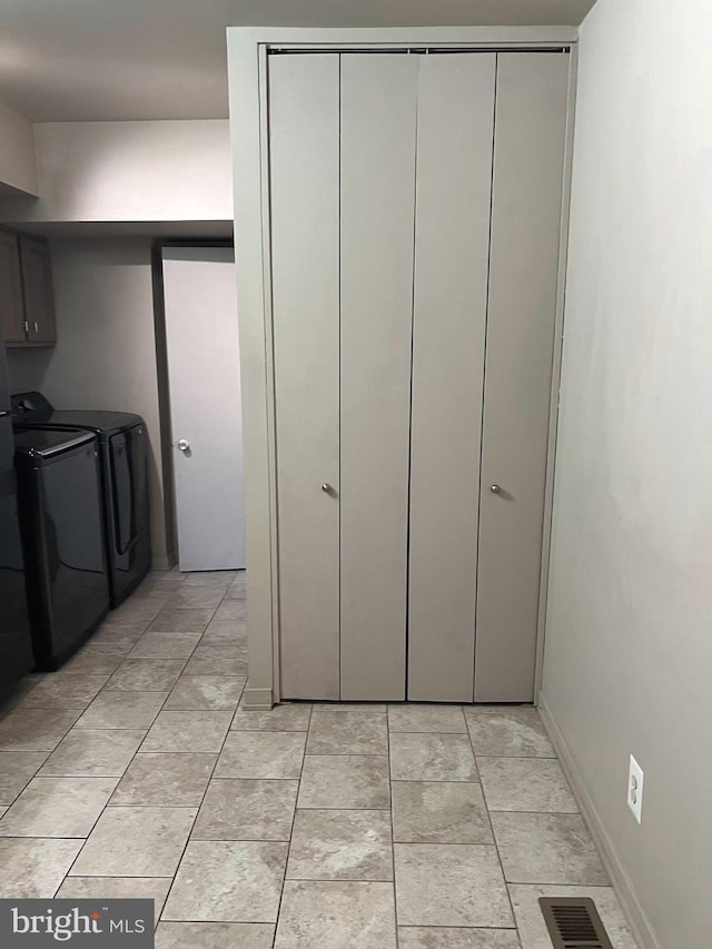 interior space featuring cabinets and washing machine and clothes dryer