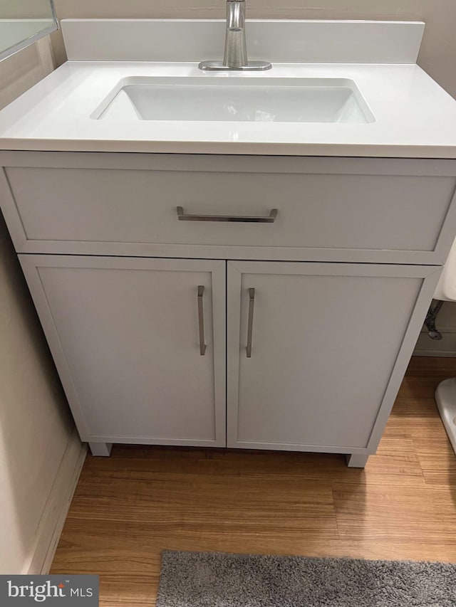 room details featuring hardwood / wood-style floors and vanity