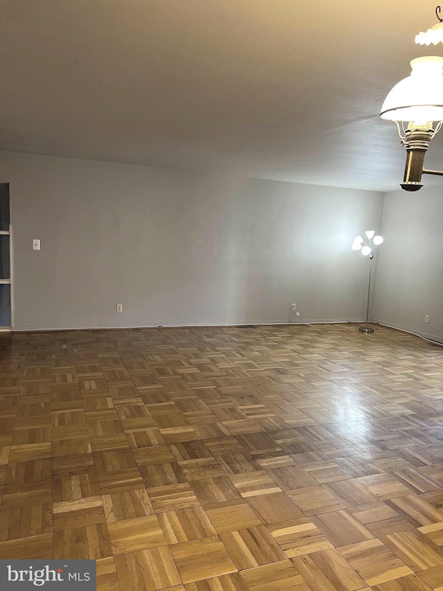 unfurnished room with dark parquet flooring