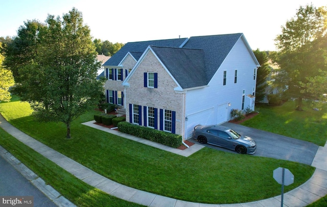 view of front of house with a front yard and a garage