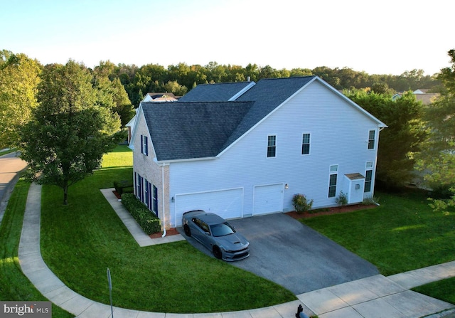 view of side of home featuring a yard and a garage