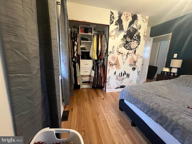 bedroom with a closet and light hardwood / wood-style floors