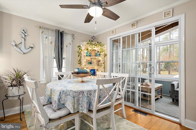 dining room featuring hardwood / wood-style flooring, ceiling fan, and crown molding