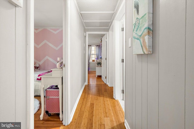 hallway with hardwood / wood-style floors