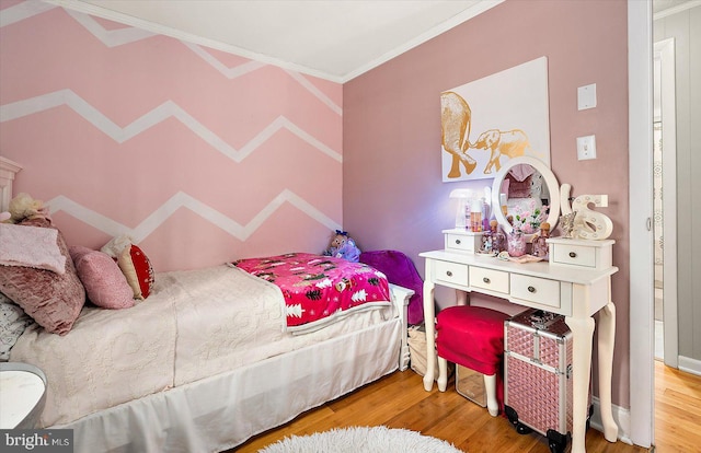 bedroom featuring crown molding and hardwood / wood-style flooring