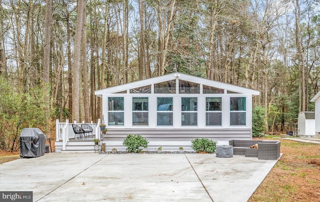 view of outbuilding featuring a sunroom