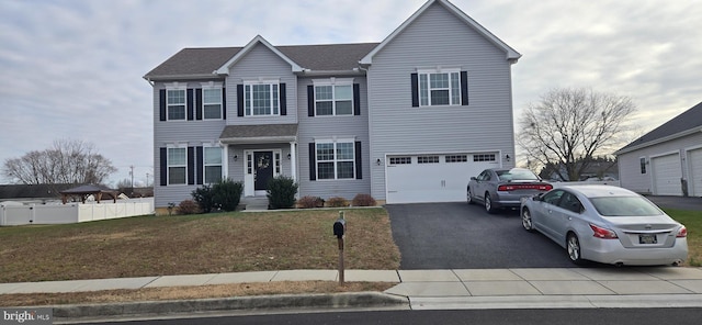 view of front of house featuring a garage and a front yard