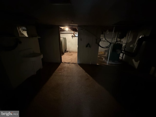 basement with water heater and carpet