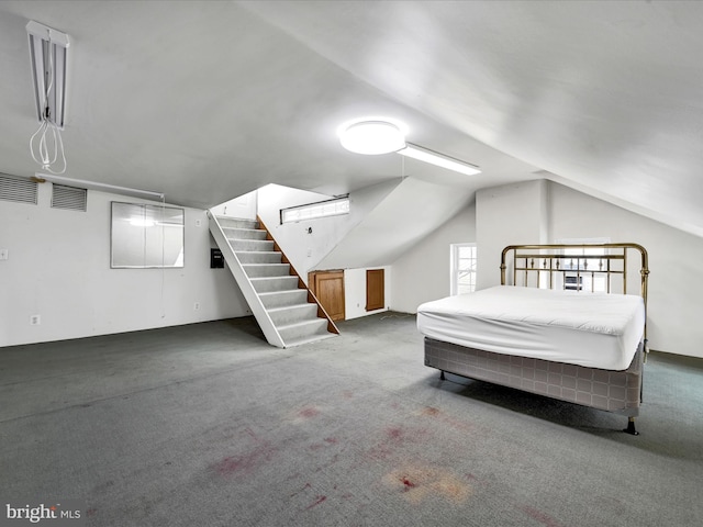 carpeted bedroom featuring lofted ceiling