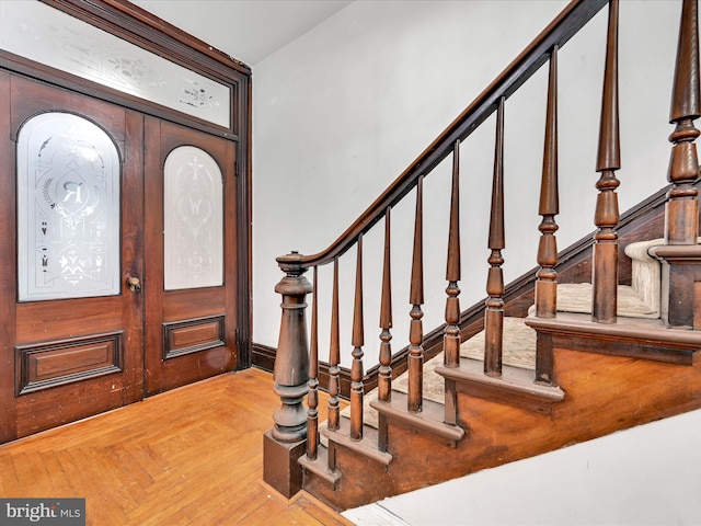 foyer entrance with parquet flooring and french doors