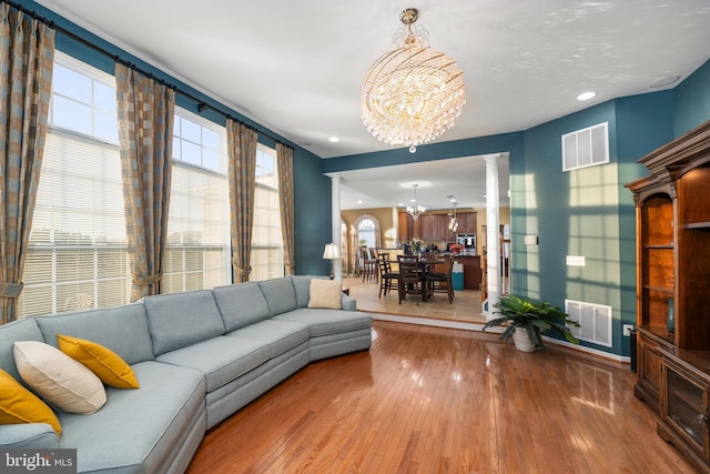 living room featuring hardwood / wood-style flooring and a chandelier