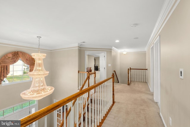 corridor featuring crown molding, light carpet, and an inviting chandelier