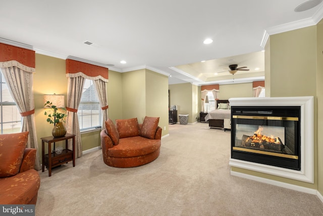 sitting room with ceiling fan, plenty of natural light, and light colored carpet