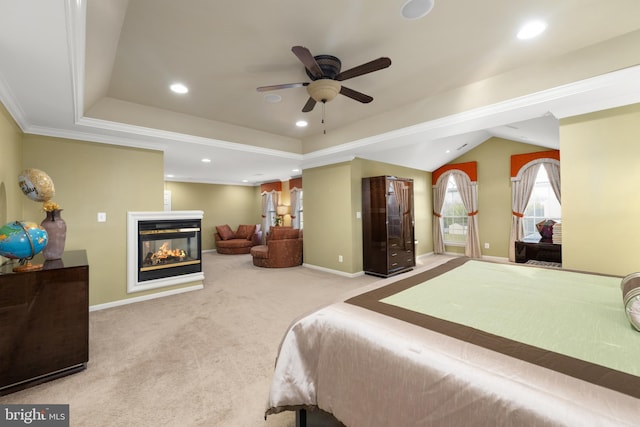 carpeted bedroom featuring ceiling fan, a multi sided fireplace, crown molding, and vaulted ceiling