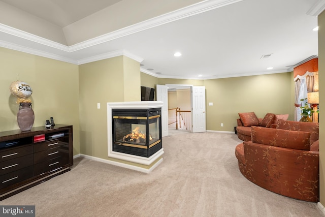 carpeted living room with a multi sided fireplace and ornamental molding