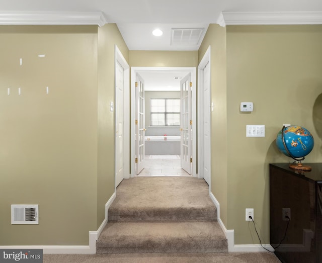 stairs featuring carpet and crown molding