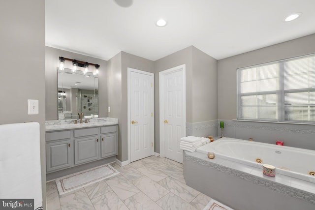 bathroom featuring vanity and independent shower and bath