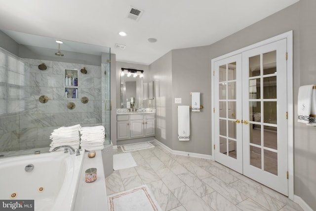 bathroom featuring french doors, vanity, and independent shower and bath