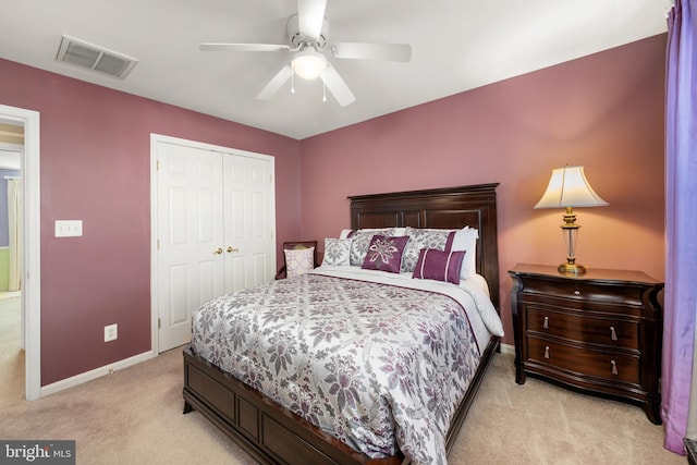 carpeted bedroom featuring a closet and ceiling fan