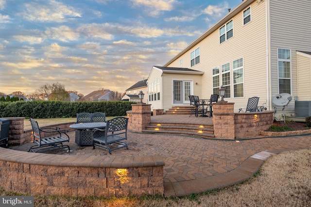 patio terrace at dusk with central air condition unit