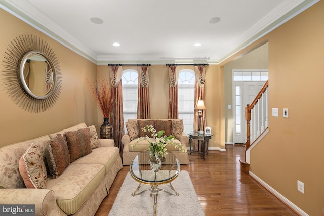 living room with hardwood / wood-style flooring and crown molding