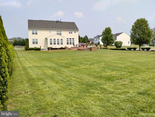 rear view of property with a lawn