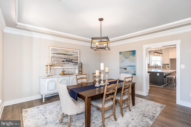 dining space with crown molding, dark hardwood / wood-style flooring, and a chandelier