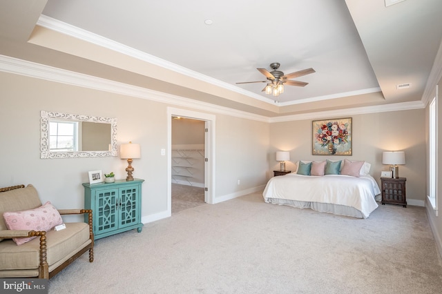 bedroom featuring crown molding, light colored carpet, a raised ceiling, and ceiling fan