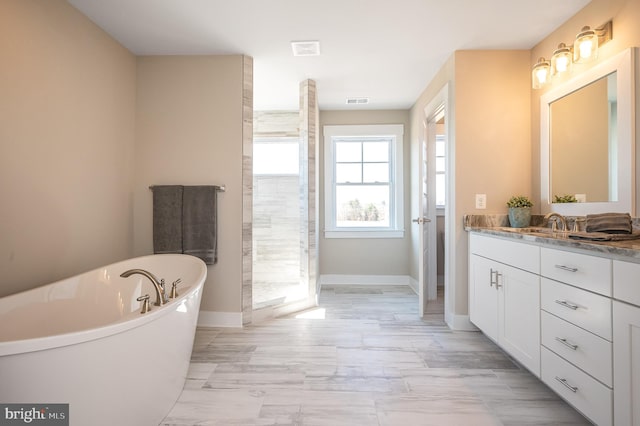 bathroom featuring vanity and plus walk in shower