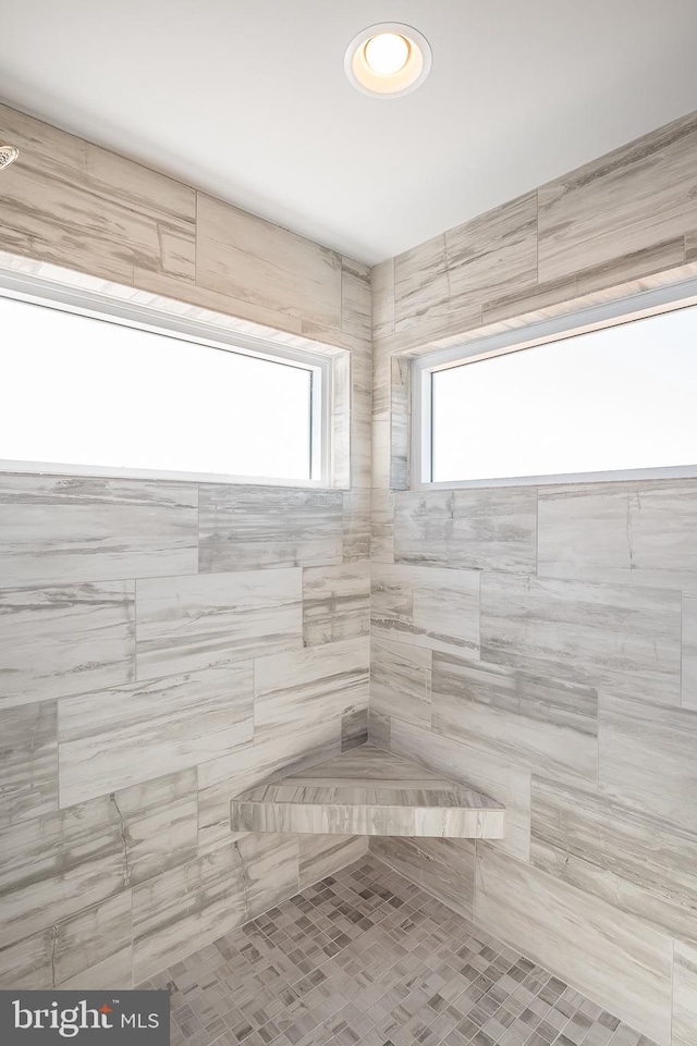 bathroom with a tile shower