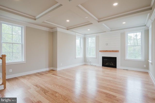 unfurnished living room with a fireplace, ornamental molding, coffered ceiling, and light hardwood / wood-style flooring